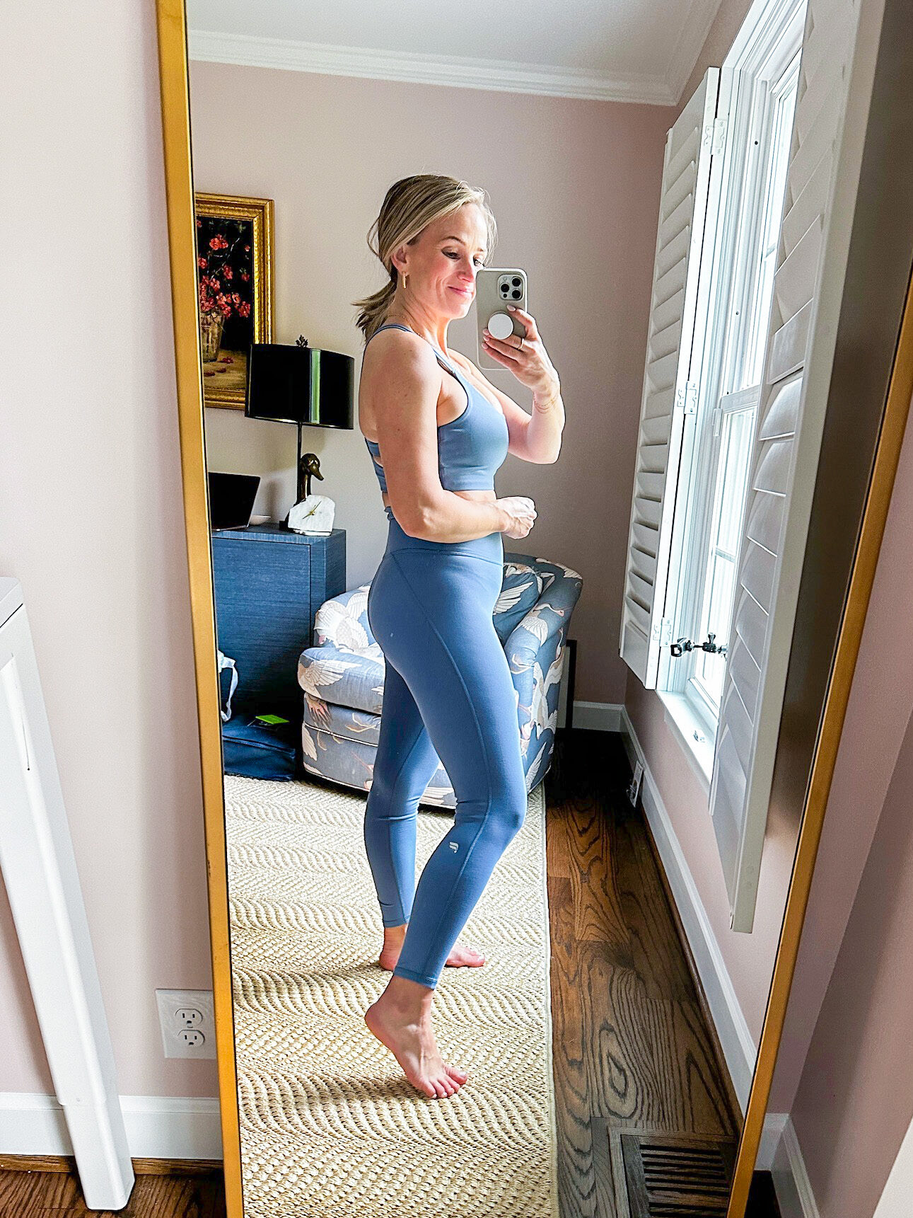 TeriLyn Adam's wearing the Principal Low Impact Bra and the Define the PowerHold High-Waisted 7/8 legging in Elemental Blue